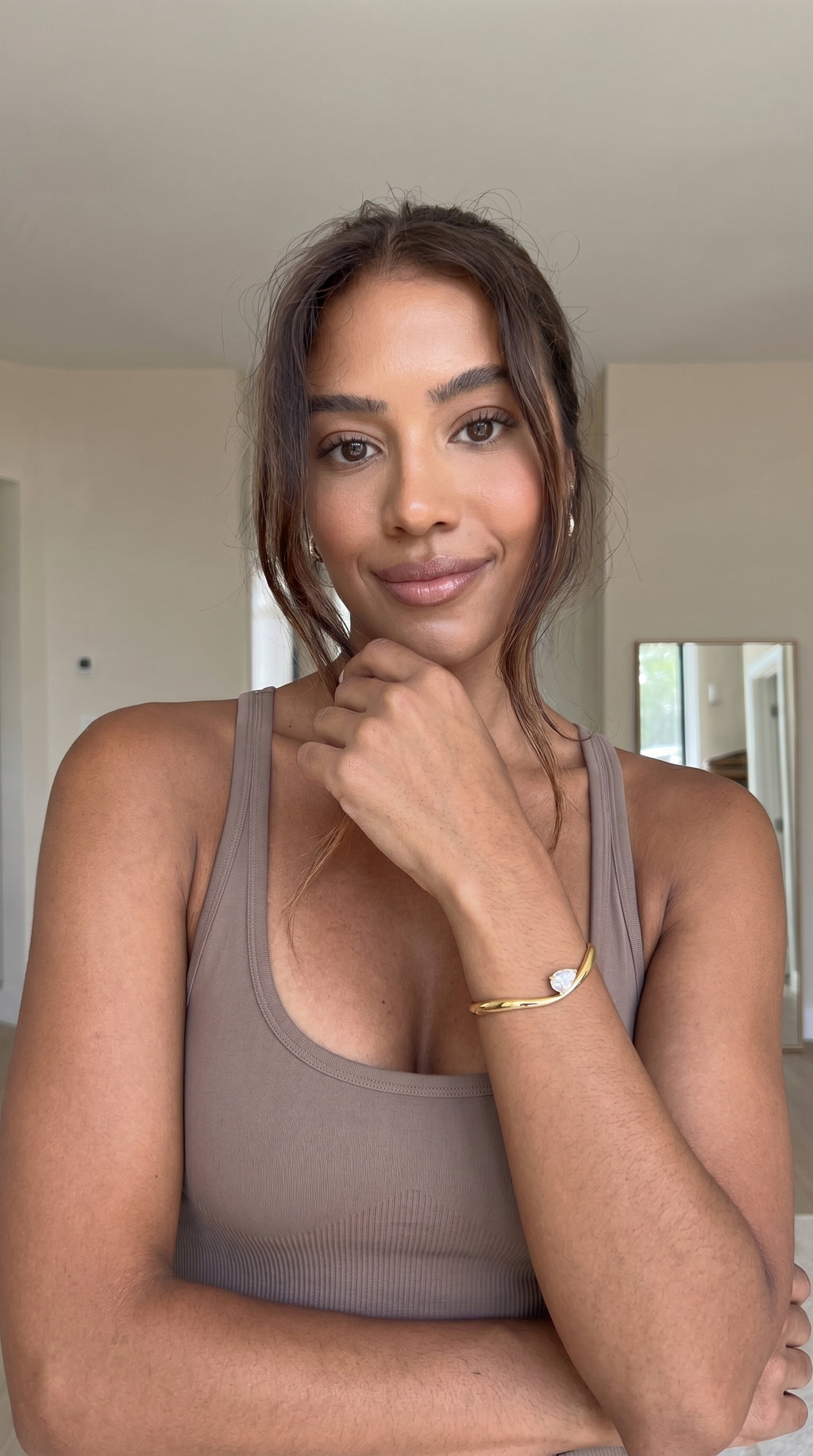Woman wearing a brown tank top indoors