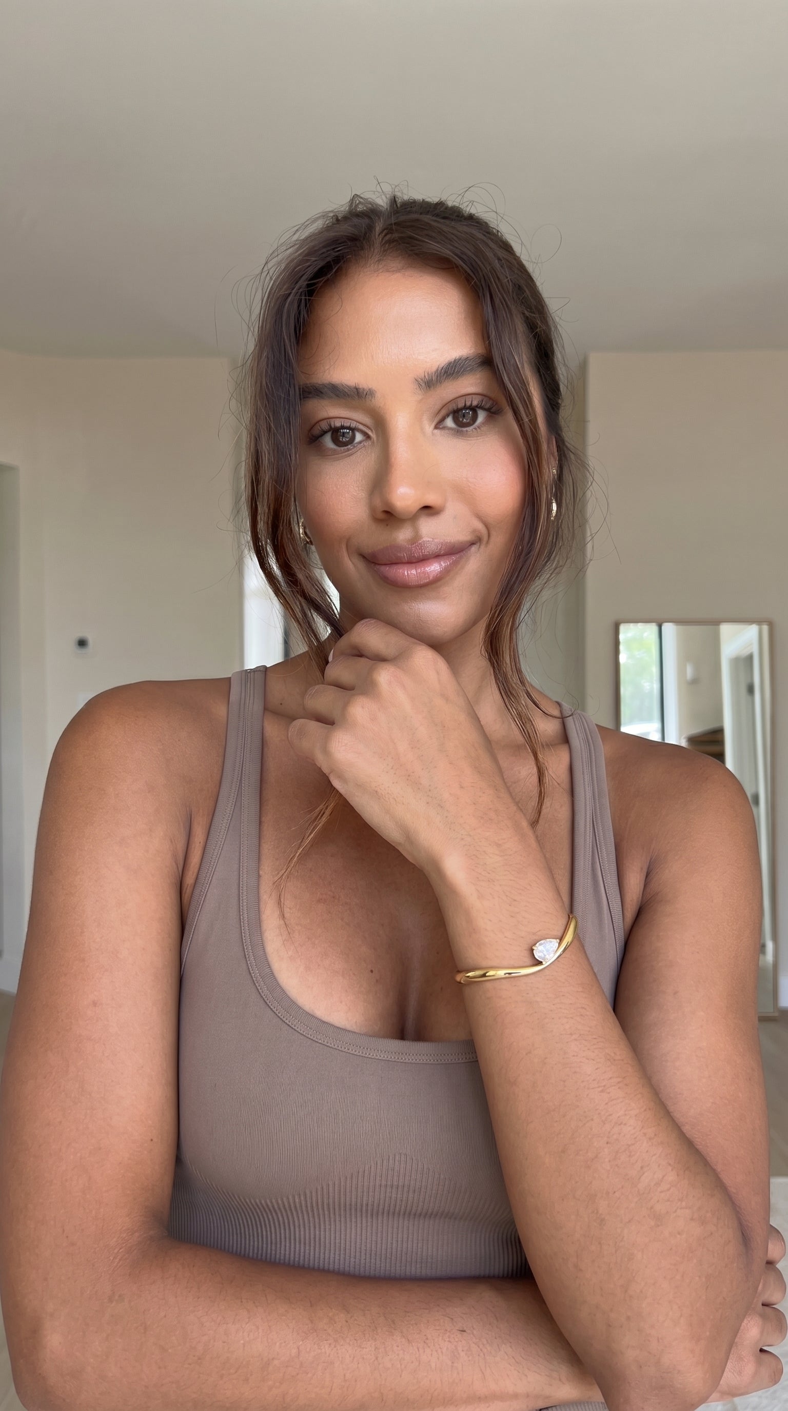 Woman wearing a brown tank top indoors