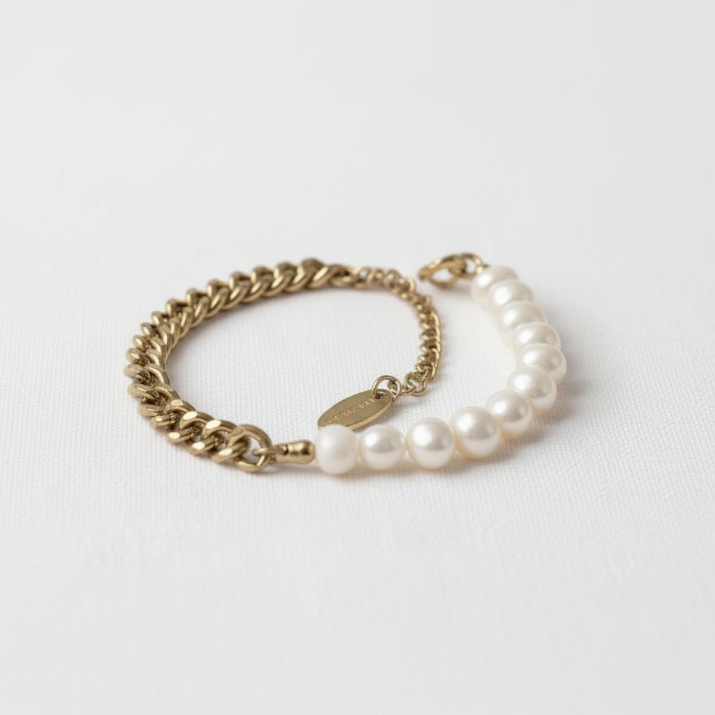 Pearl bracelet with gold chain on a white background
